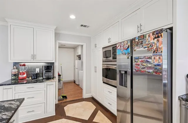 a kitchen with stainless steel appliances a refrigerator and cabinets