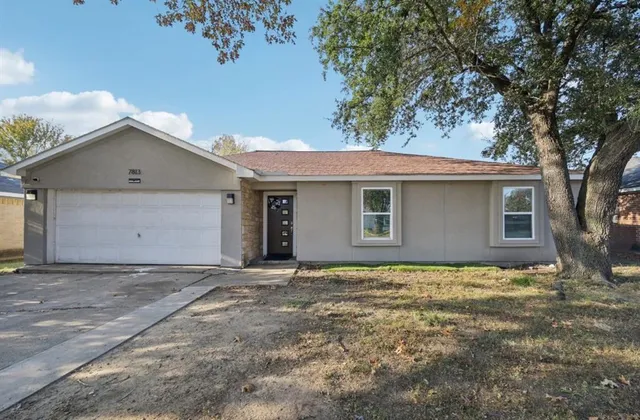 a house with a tree in the background