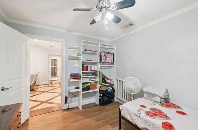 a bedroom with bed and a chandelier