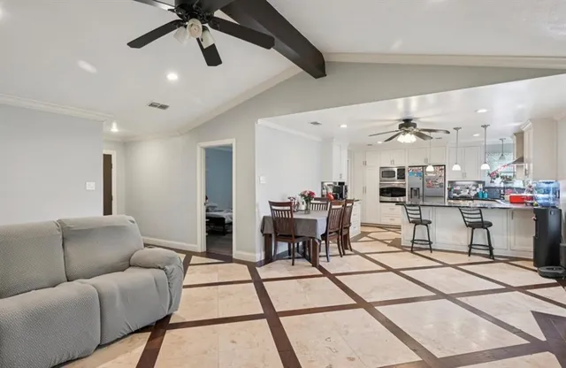 a living room with furniture and kitchen view