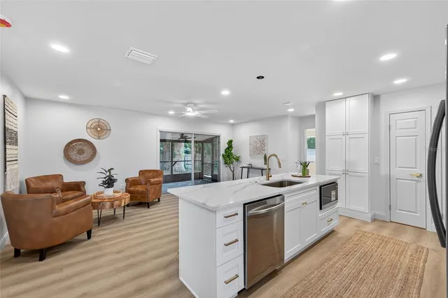 a kitchen with granite countertop a sink and stove top oven