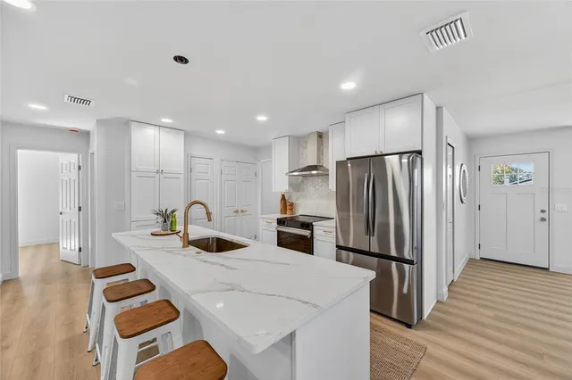 a living room with furniture a window and a potted plant