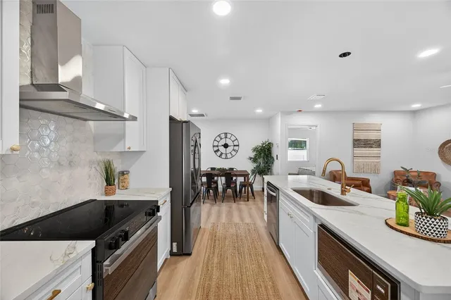 a living room with furniture a window and a clock