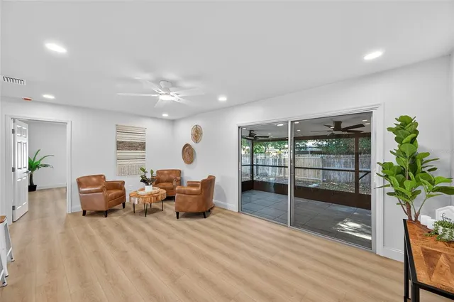 a bedroom with a large bed and a potted plant