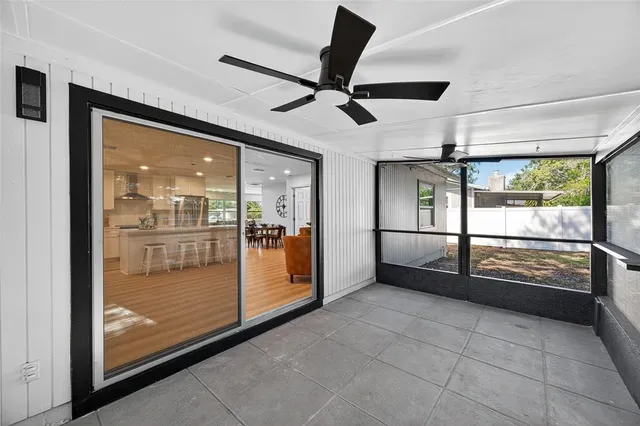 a view of a house with a yard and large tree