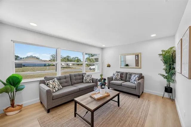 a living room with furniture and a large window