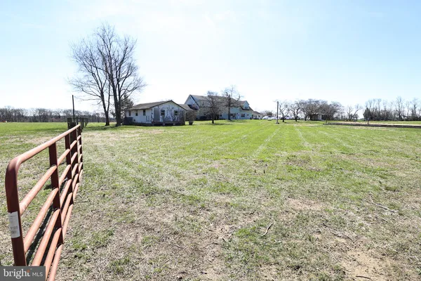 a living room with furniture and a book shelf