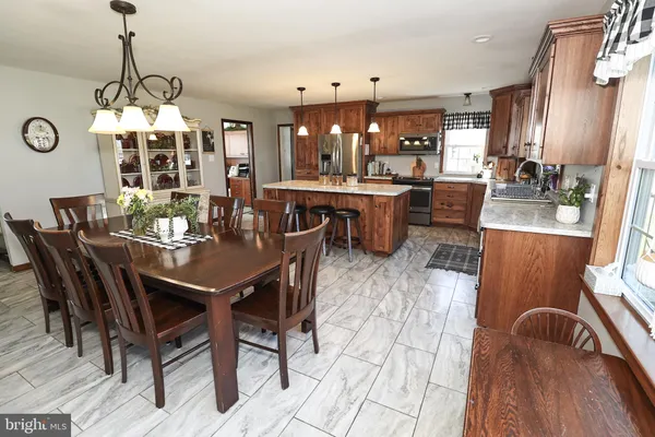 a kitchen with granite countertop a cabinets and a stove top oven