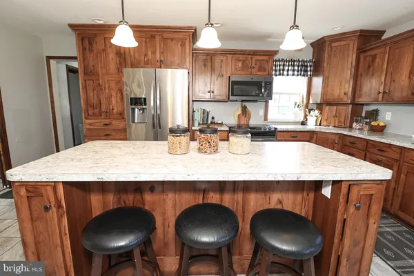 a white refrigerator freezer and a stove sitting inside of a kitchen