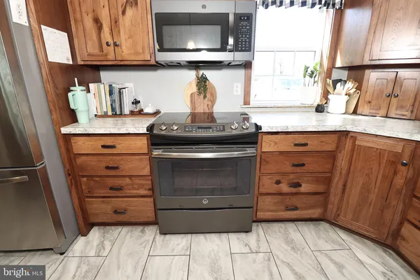a kitchen with a table chairs and a window