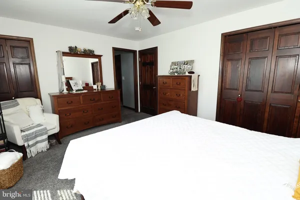 a bedroom with a bed and a book shelf