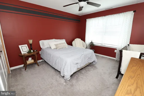 a living room with furniture and a book shelf