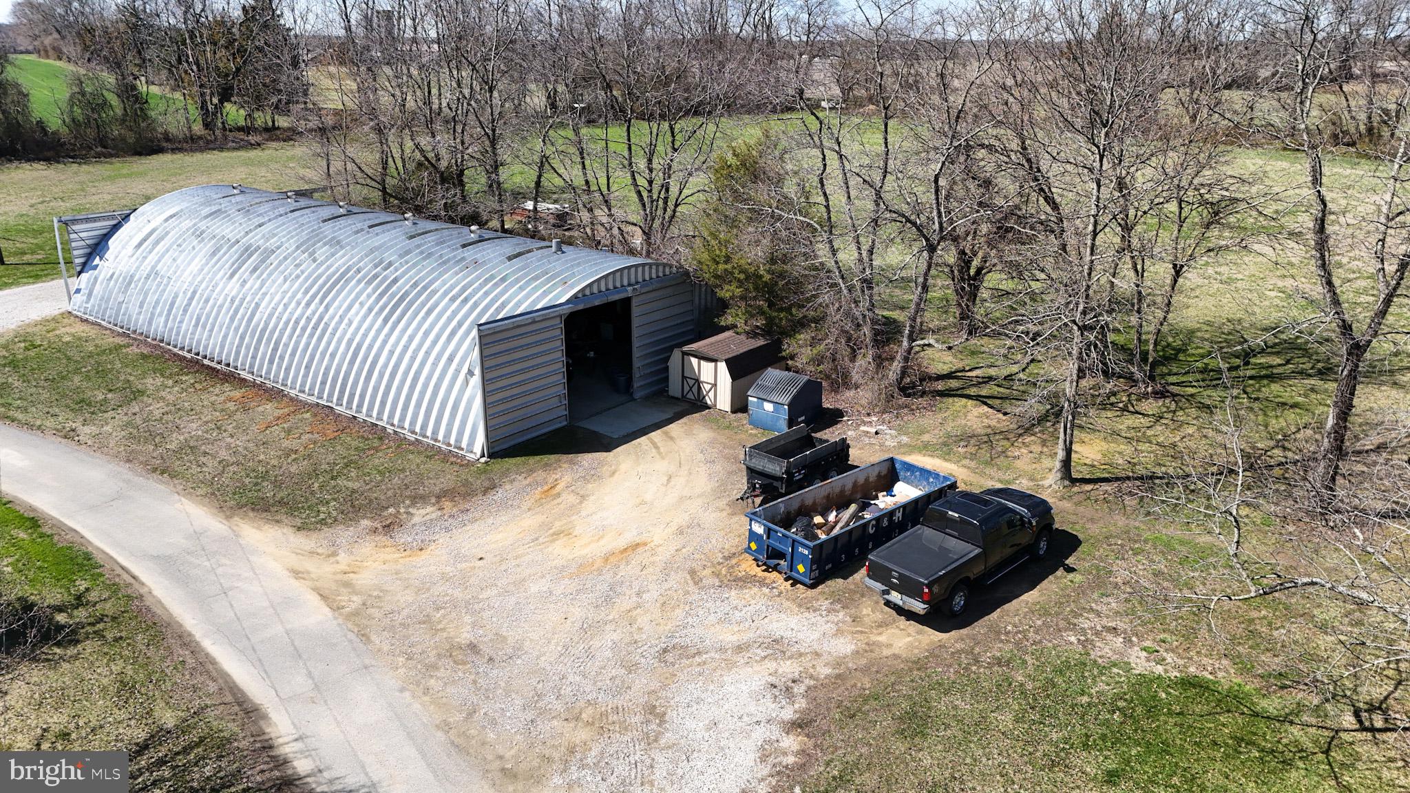 133 Avis Mill Road Pilesgrove, NJ 08098 - Photo 55 of 58 a view of a backyard with a large tree and a yard