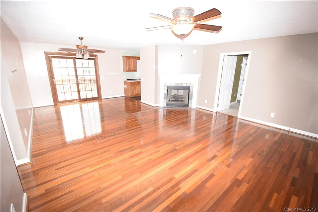 171 Hunters Trace Rutherfordton, NC 28139 - Photo 2 of 24 wooden floor in an empty room with a window