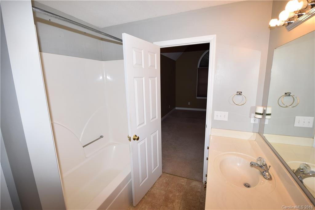 171 Hunters Trace Rutherfordton, NC 28139 - Photo 6 of 24 a bathroom with a tub sink and mirror
