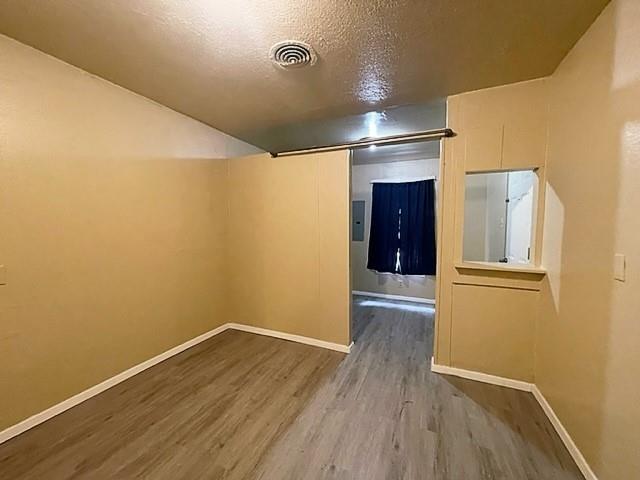 10 Pershing Drive, Unit A Denison, TX 75020 - Photo 12 of 15 a view of empty room with wooden floor