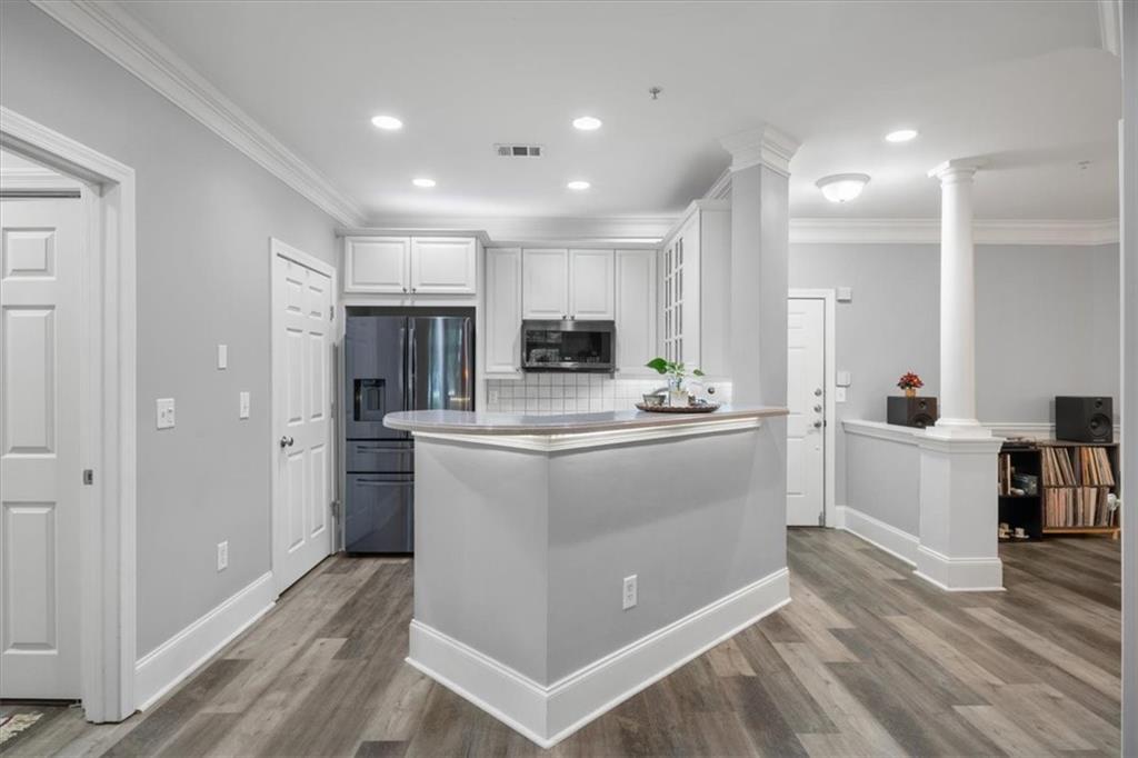 4100 Paces Walk Southeast, Unit 1101 Atlanta, GA 30339 - Photo 9 of 36 a kitchen with white cabinets and white appliances