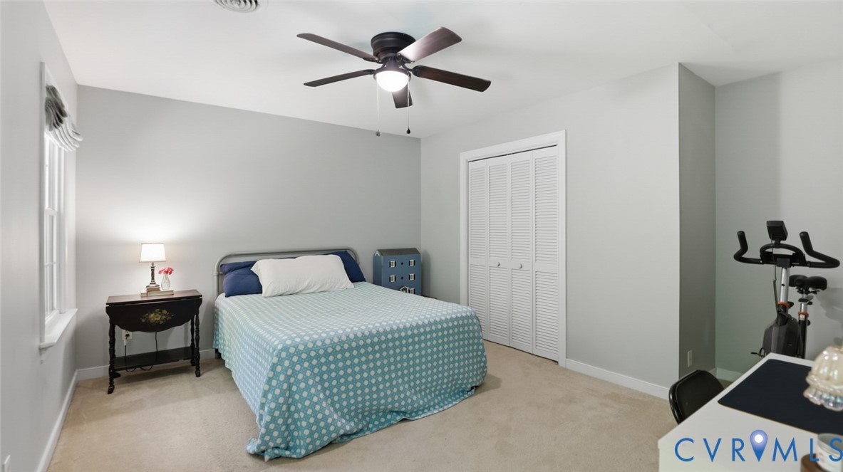 10716 Chalkley Road Richmond, VA 23237 - Photo 31 of 46 a bedroom with a bed and a chandelier