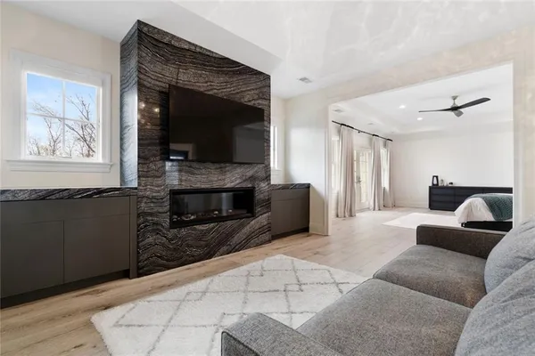 a living room with furniture a flat screen tv and a fireplace