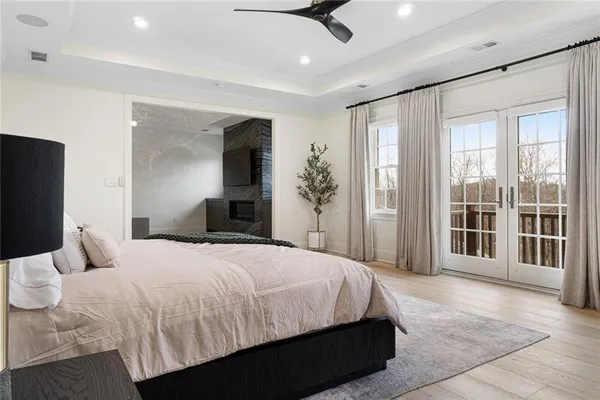 a bedroom with a large bed and a chandelier