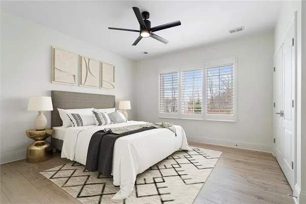 a bedroom with a bed and wooden floor