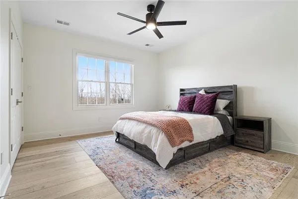 a spacious bedroom with a bed and a window