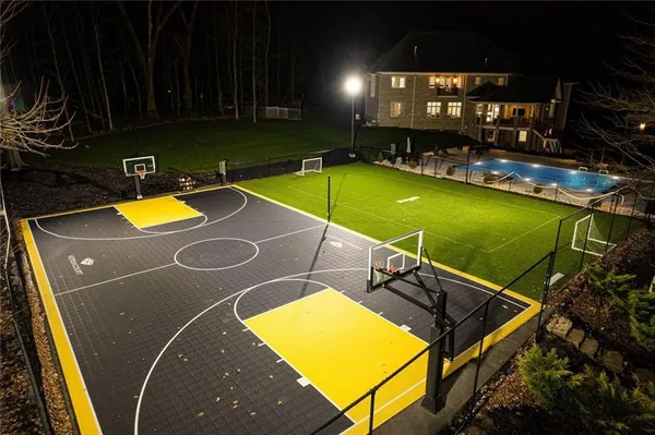 a view of a swimming pool with lounge chair and dinning table