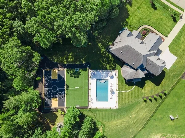 an aerial view of a house with a yard