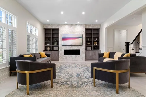 a living room with fireplace furniture and a flat screen tv