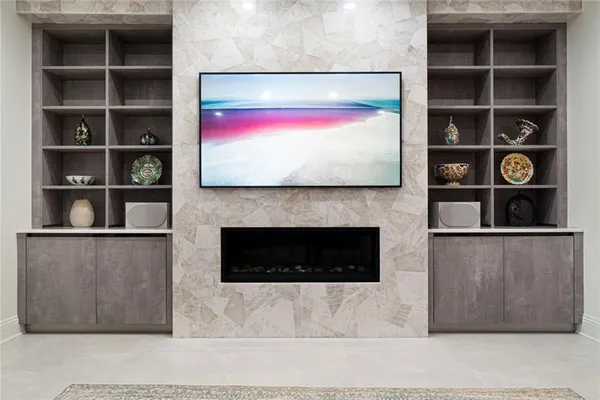 a living room with flat screen tv and a fireplace