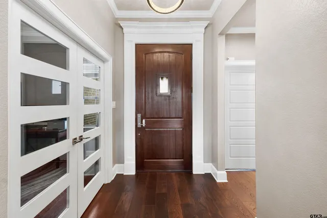 a view of a livingroom with wooden floor and staircase