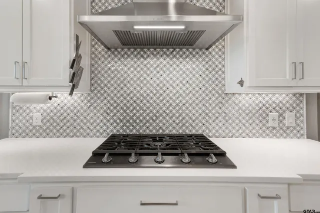 a large kitchen with stainless steel appliances lots of counter space and wooden floor