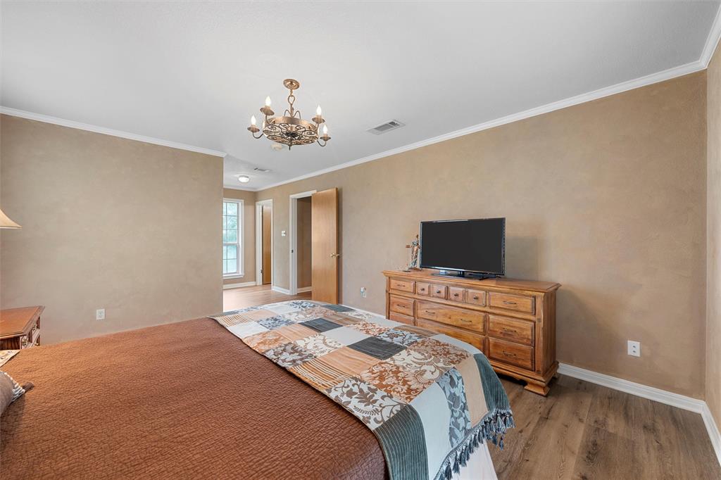 3057 Holy Road Abbott, TX 76621 - Photo 25 of 39 a bedroom with a bed and a flat screen tv