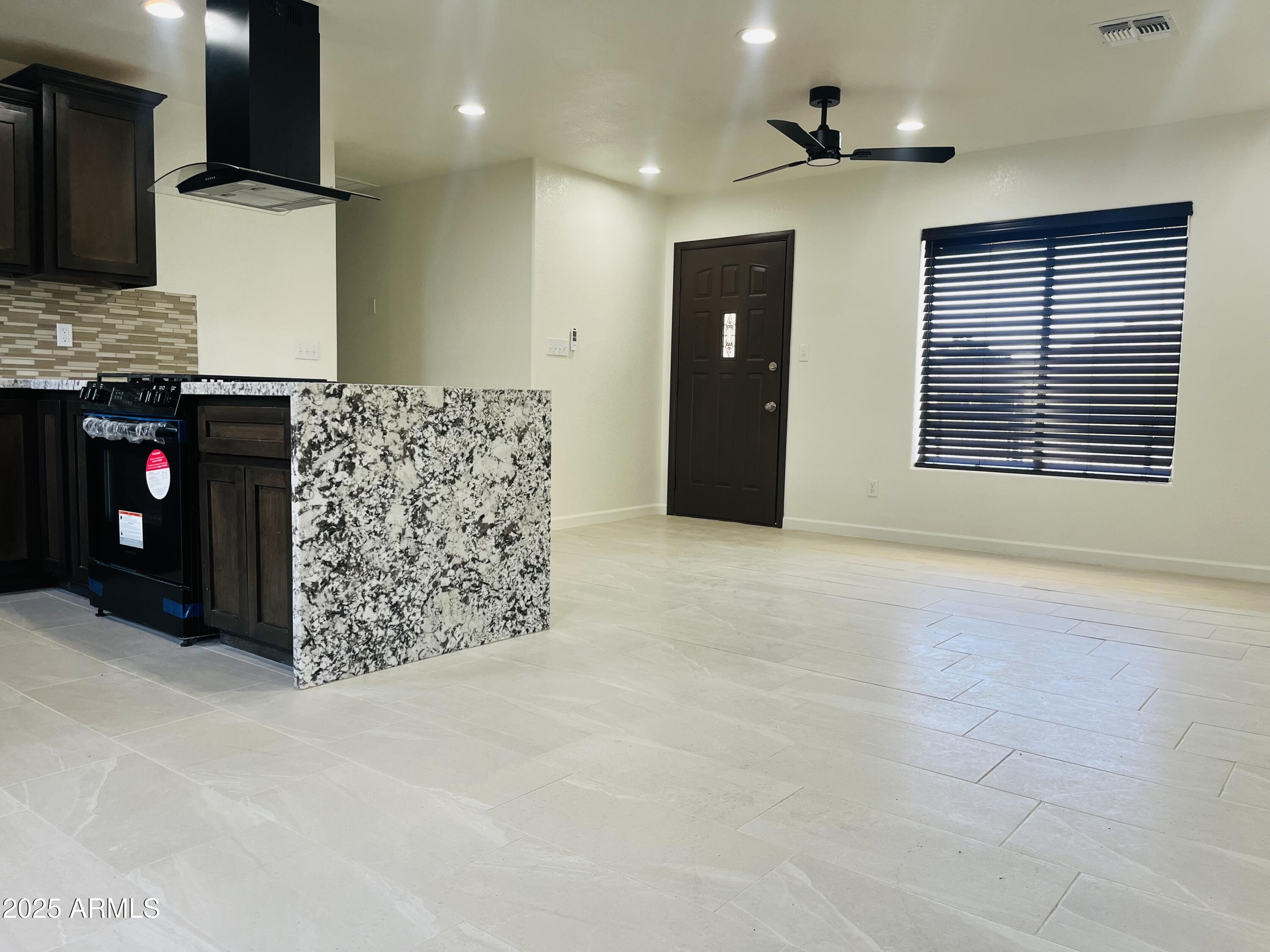 810 East 3rd Street Douglas, AZ 85607 - Photo 2 of 12 a living room with furniture a flat screen tv and a fireplace