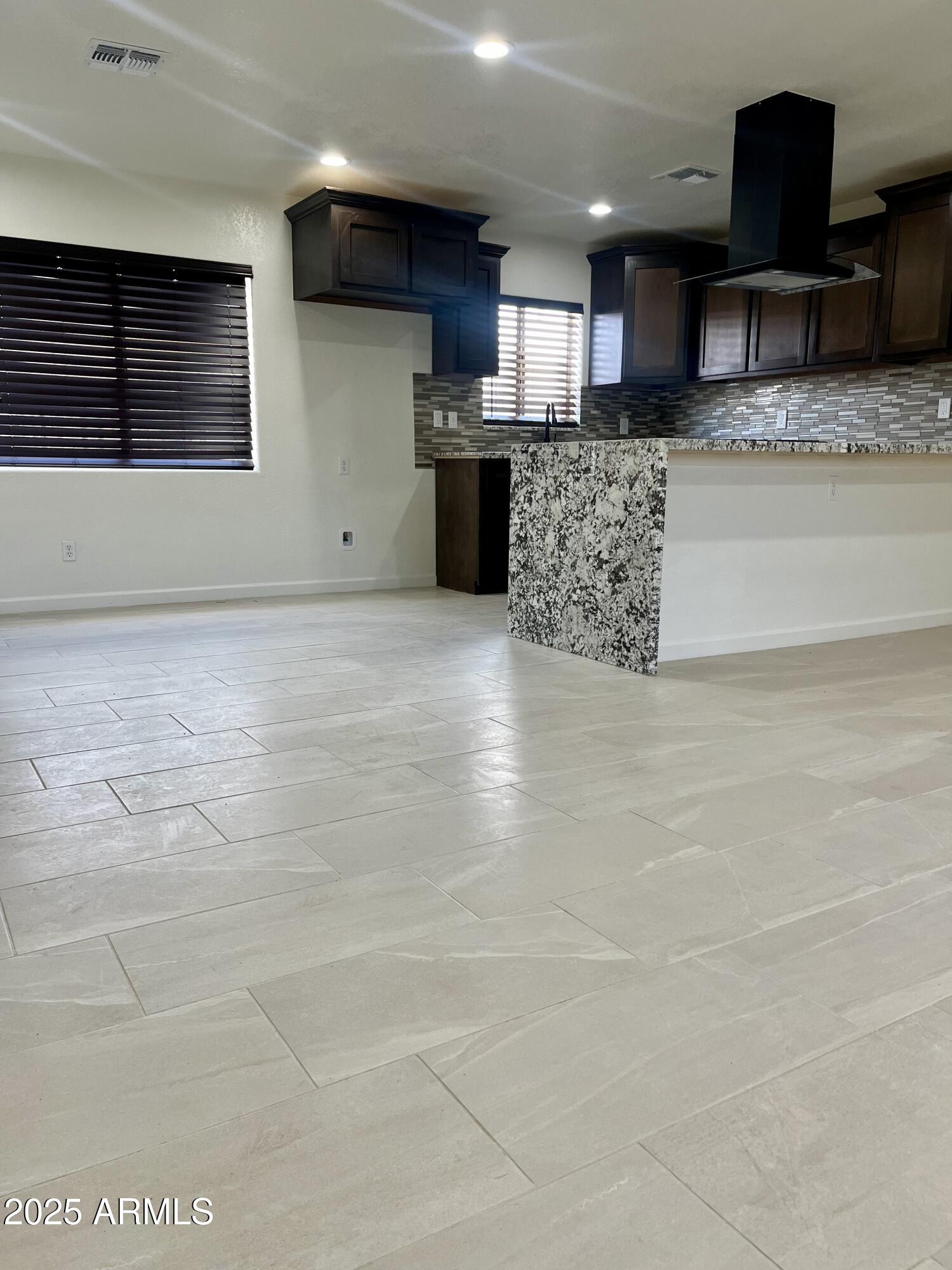 810 East 3rd Street Douglas, AZ 85607 - Photo 3 of 12 a large kitchen with stainless steel appliances kitchen island granite countertop a sink a stove and cabinets