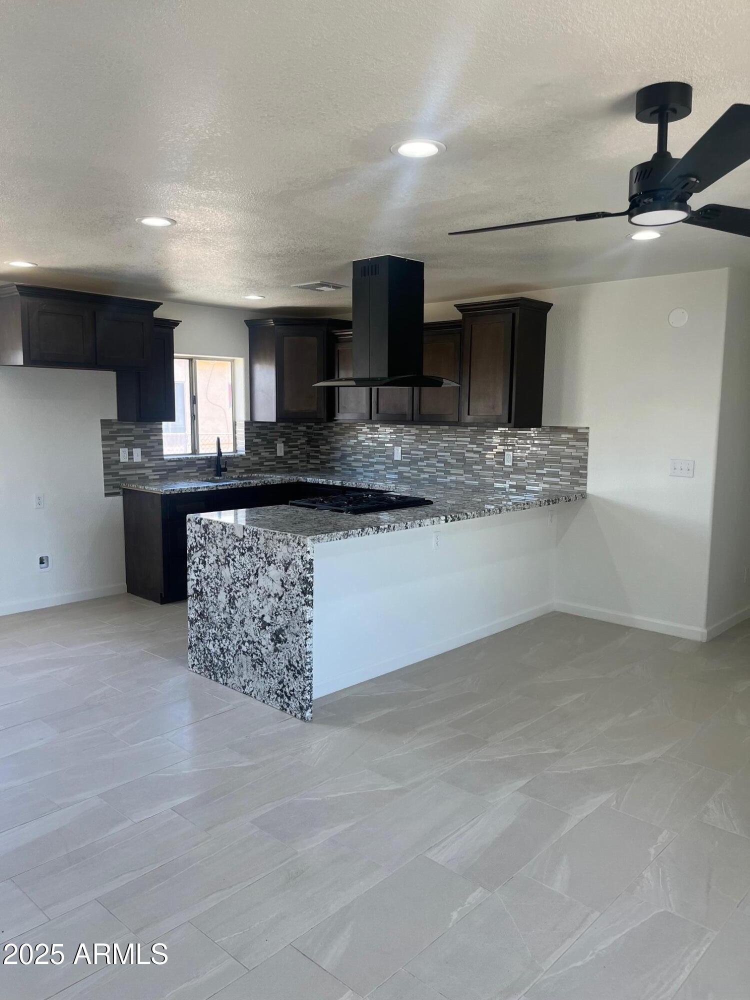 810 East 3rd Street Douglas, AZ 85607 - Photo 4 of 12 a kitchen with stainless steel appliances granite countertop a sink and a stove