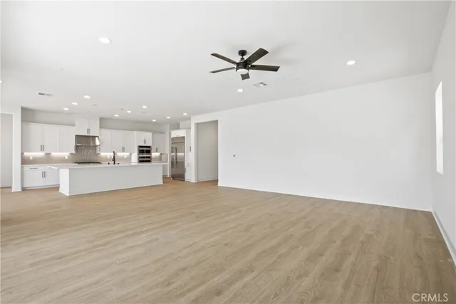 a view of a kitchen with a sink and a refrigerator
