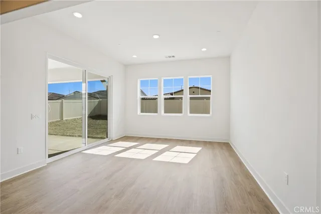 a view of an empty room with glass door