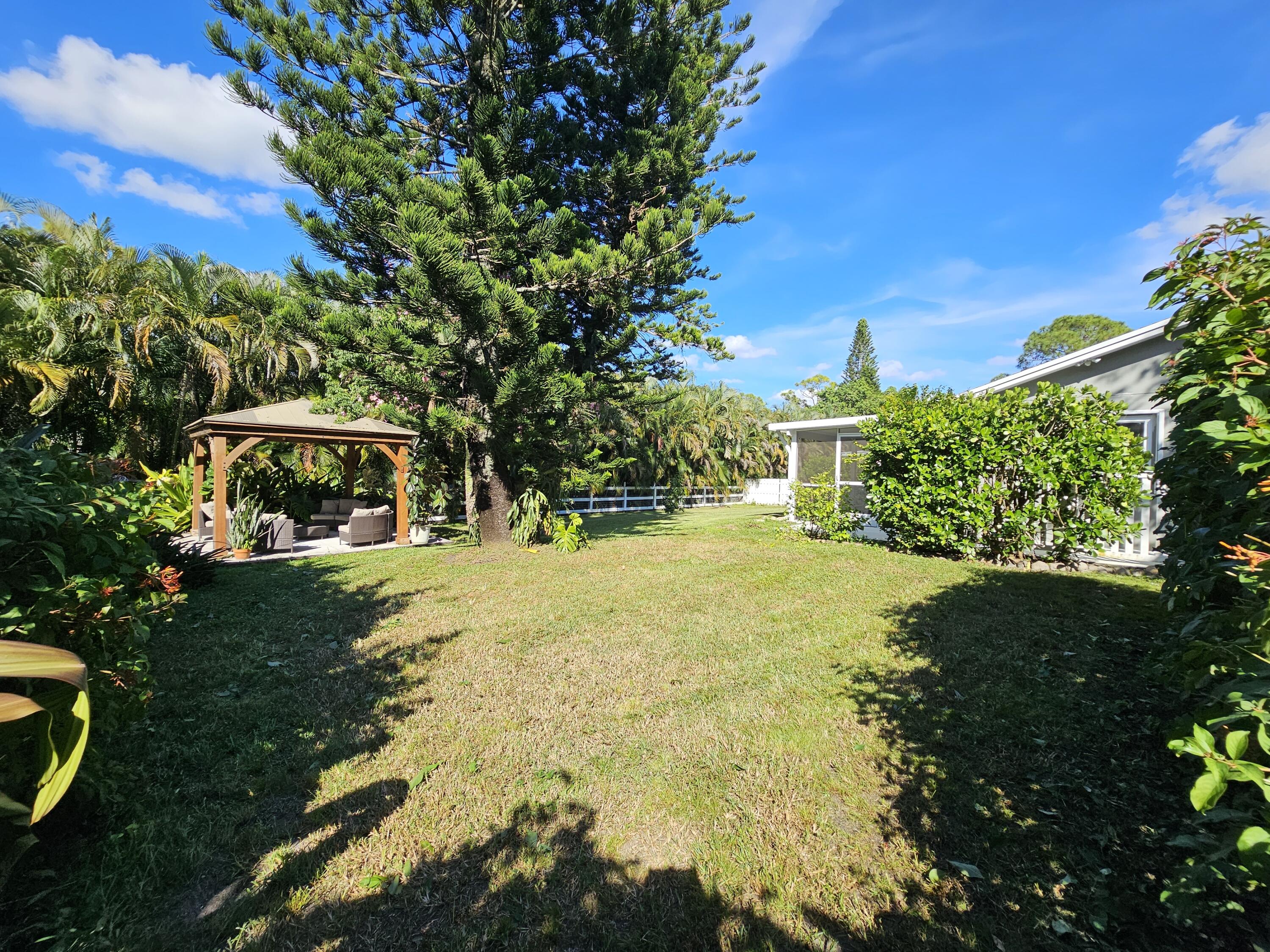 12575 52nd Road North The Acreage, FL 33411 - Photo 52 of 65 Rear side lawn overlooking gazebo area