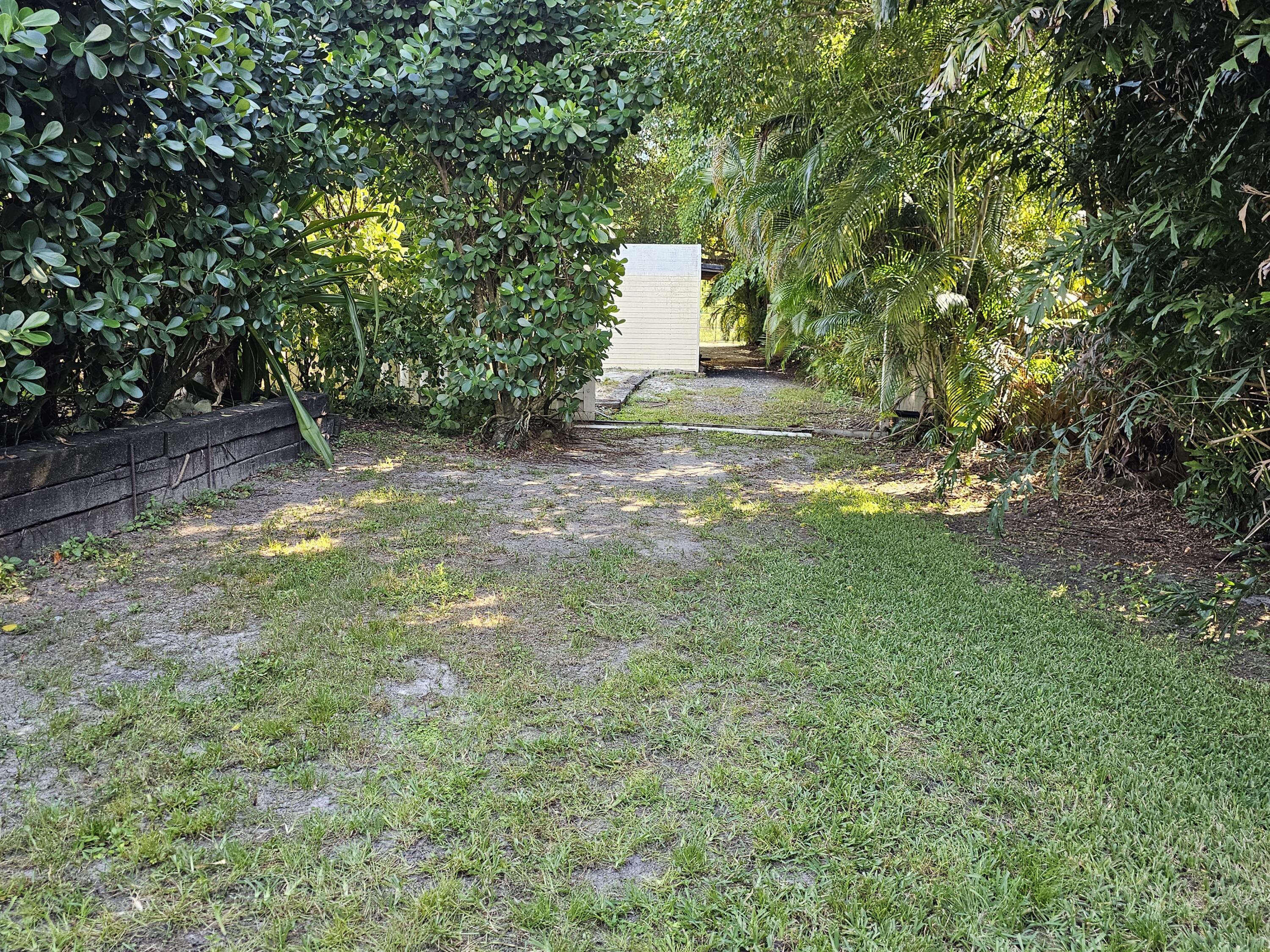 12575 52nd Road North The Acreage, FL 33411 - Photo 53 of 65 Side lawn leading to firepit