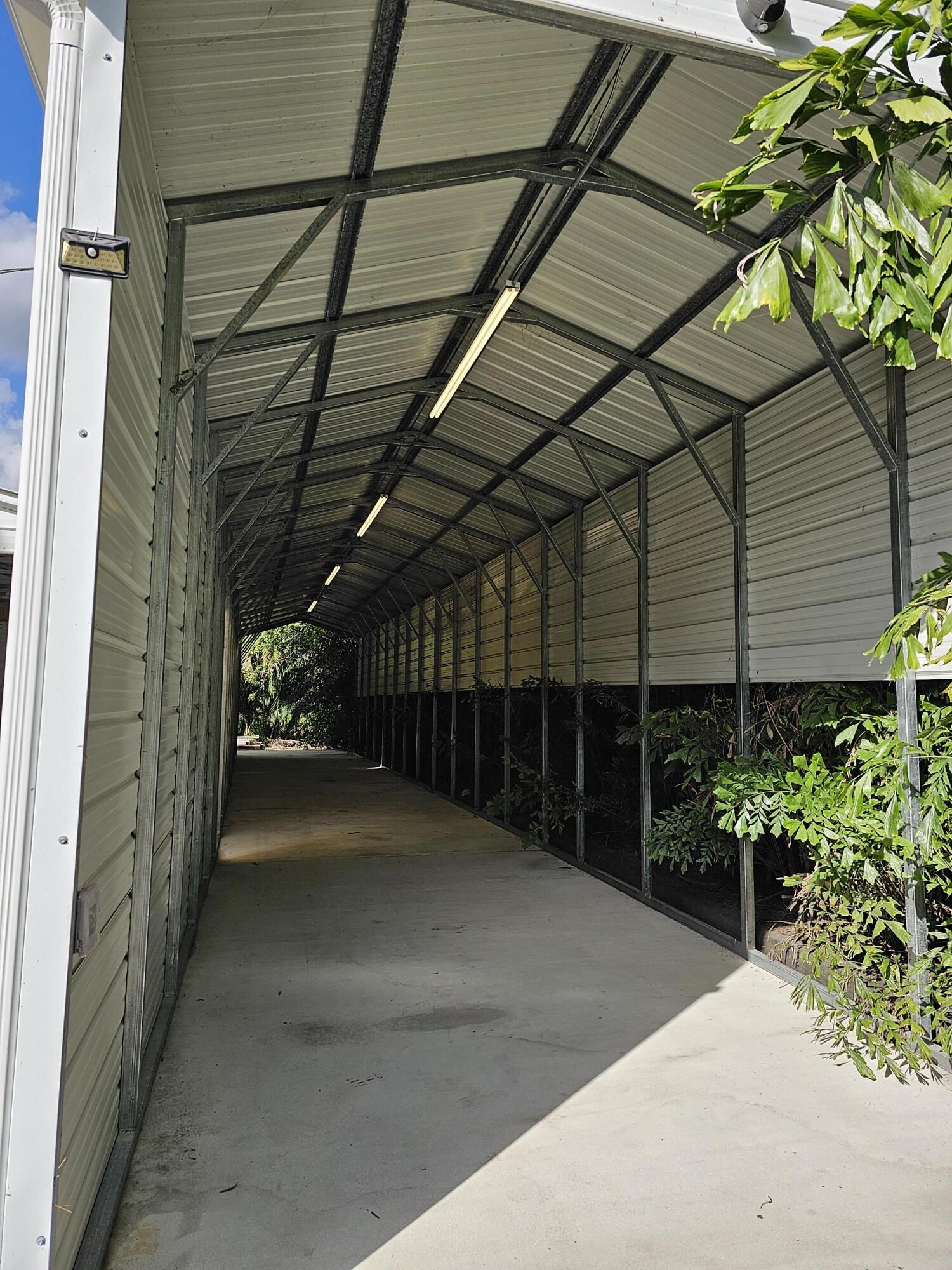 12575 52nd Road North The Acreage, FL 33411 - Photo 59 of 65 Lit Awning roughly 60' long