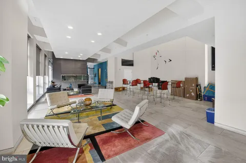 a living room with furniture kitchen view and a table