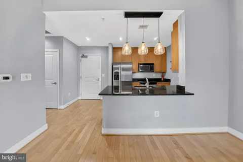 a living room with kitchen island granite countertop furniture and a fireplace