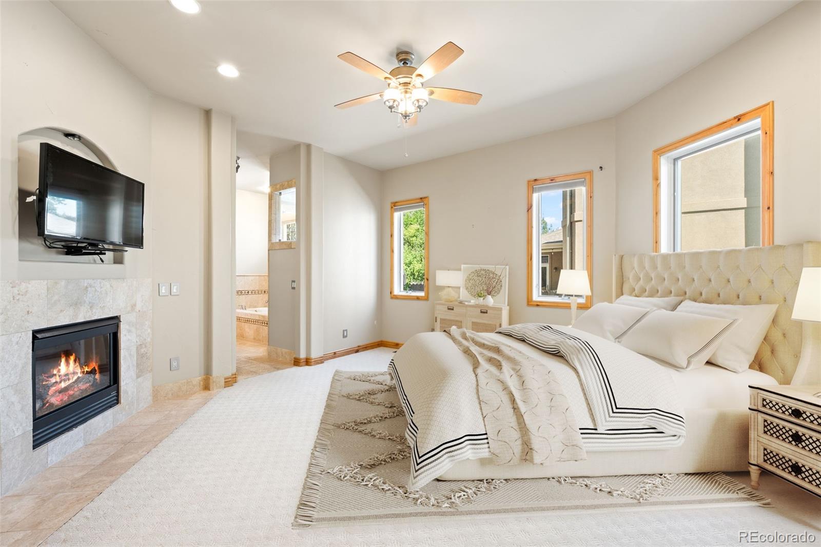 2895 South Cook Street Denver, CO 80210 - Photo 15 of 41 a bedroom with a bed and a flat screen tv