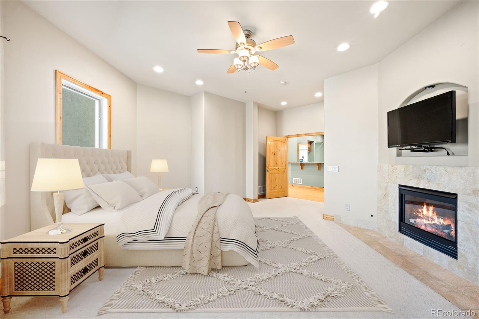 2895 South Cook Street Denver, CO 80210 - Photo 16 of 41 a living room with furniture a fireplace and a flat screen tv