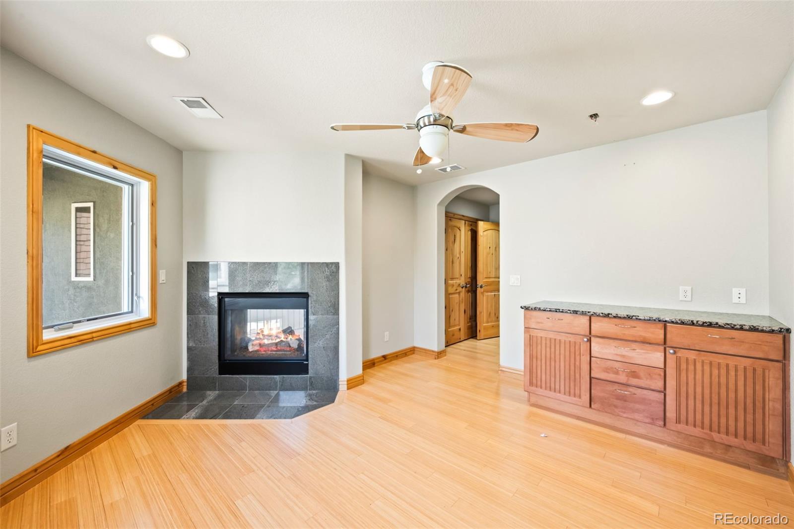 2895 South Cook Street Denver, CO 80210 - Photo 22 of 41 a view of an empty room with a fireplace and a window