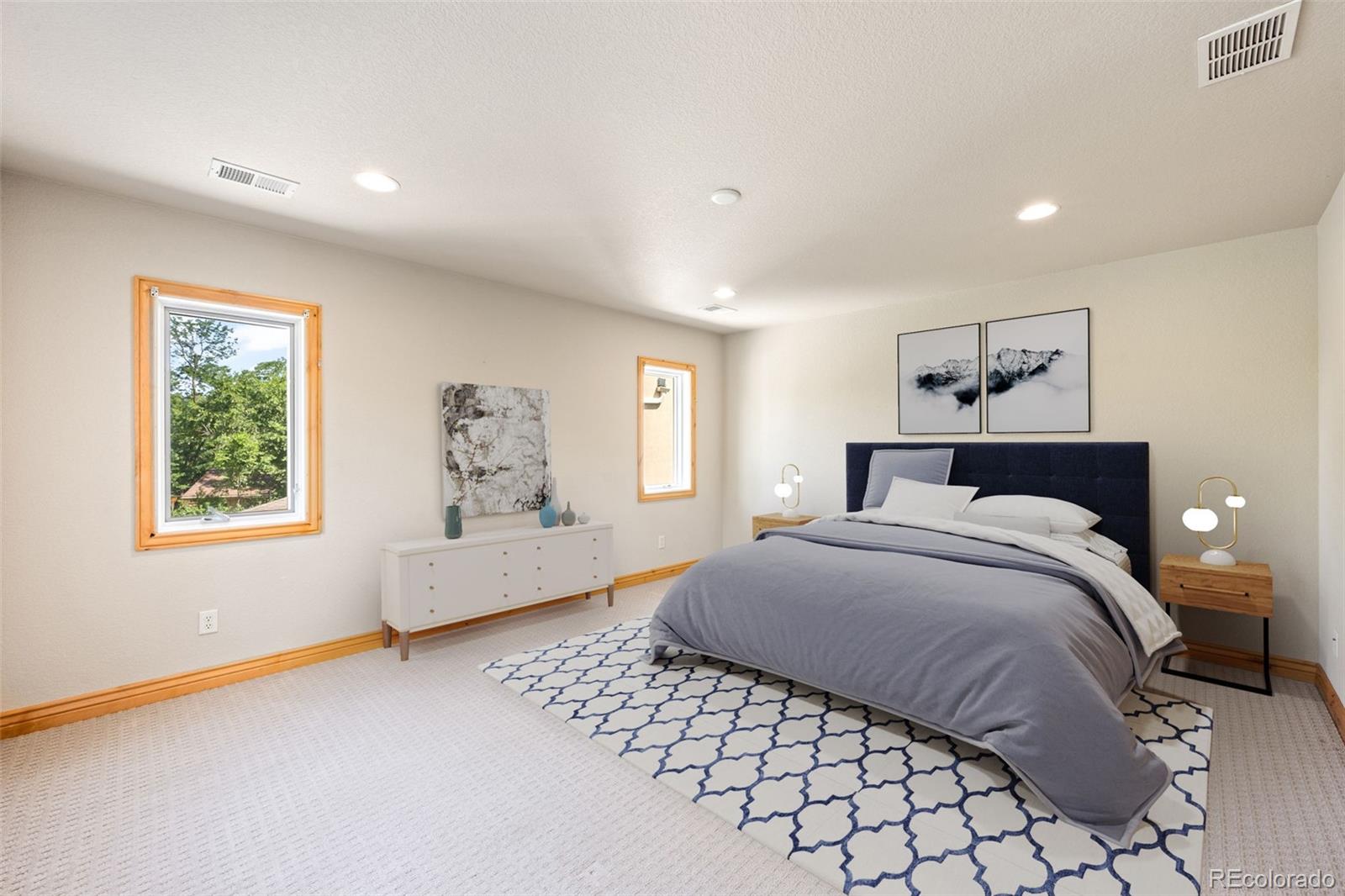 2895 South Cook Street Denver, CO 80210 - Photo 24 of 41 a spacious bedroom with a large bed and a window