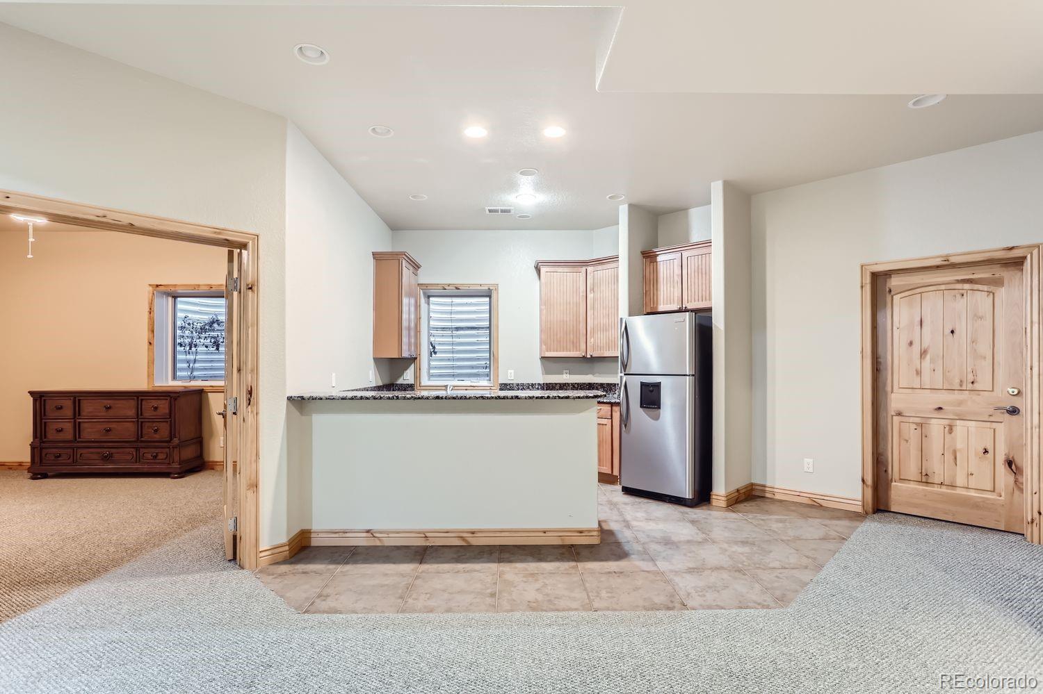 2895 South Cook Street Denver, CO 80210 - Photo 31 of 41 a kitchen with a refrigerator and a stove