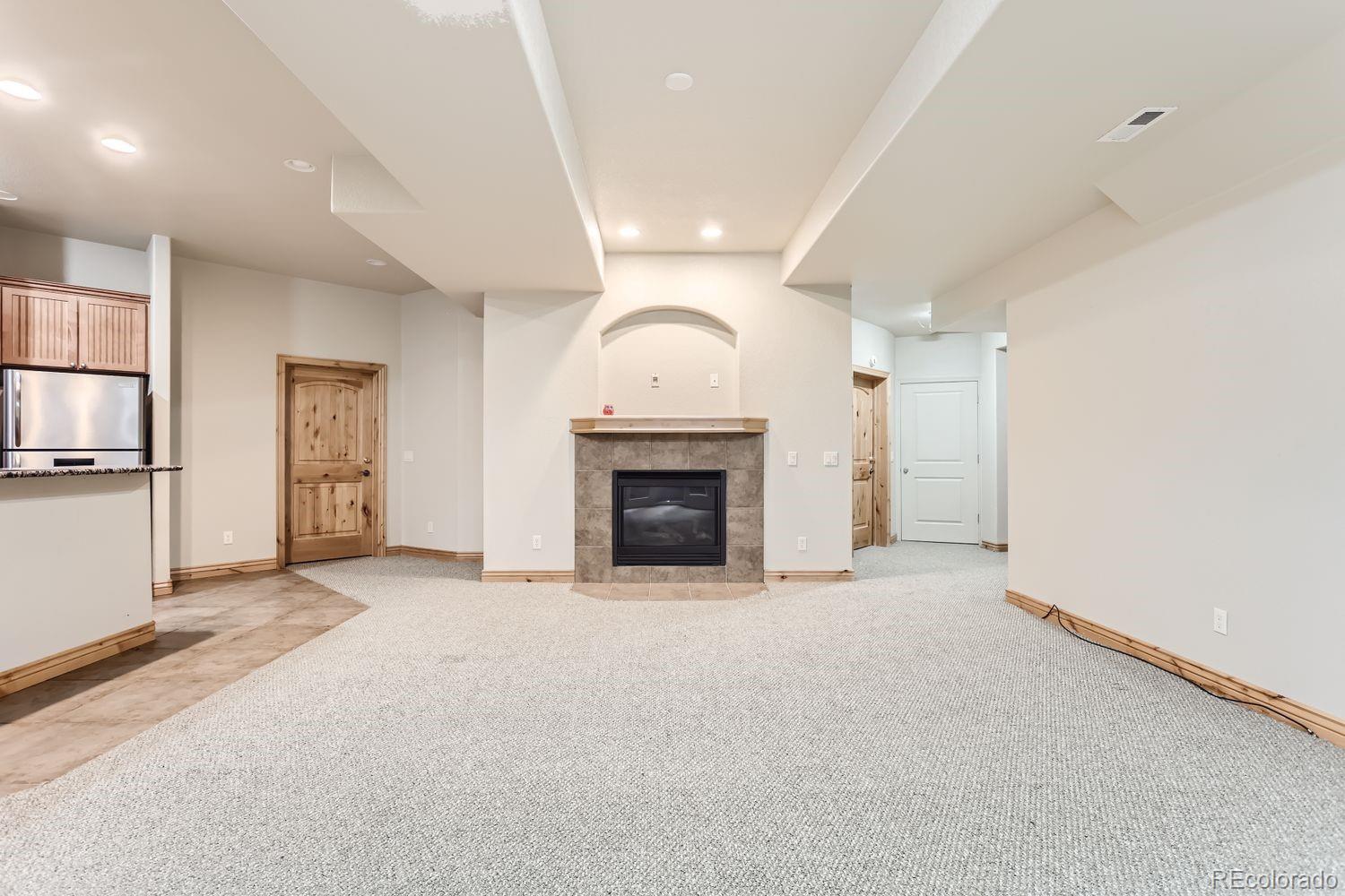 2895 South Cook Street Denver, CO 80210 - Photo 32 of 41 an empty room with windows and fireplace