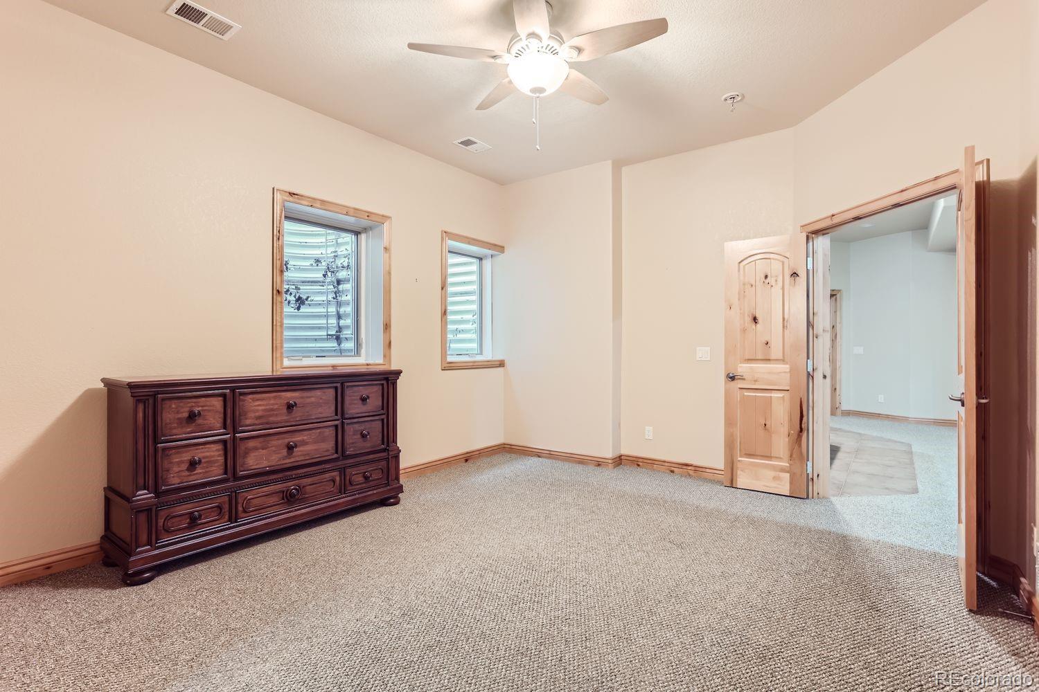 2895 South Cook Street Denver, CO 80210 - Photo 34 of 41 an empty room with windows and cabinet